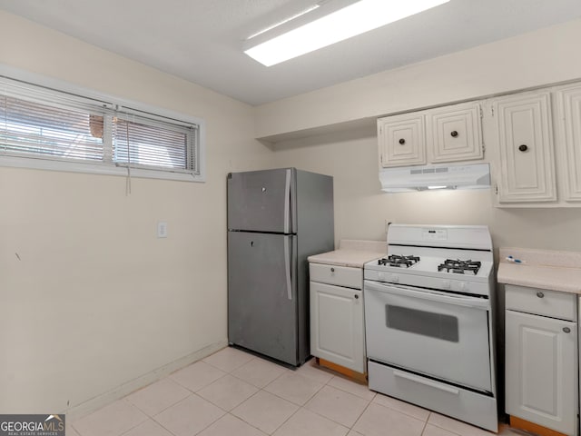 kitchen featuring light countertops, freestanding refrigerator, white cabinetry, under cabinet range hood, and white gas range oven