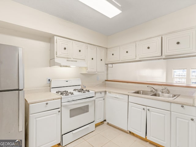 kitchen featuring white cabinets, white appliances, sink, and light tile patterned floors