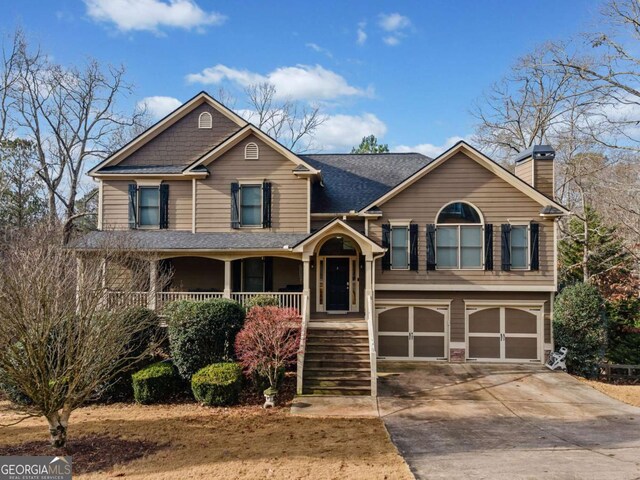 view of front of property featuring a porch and a garage