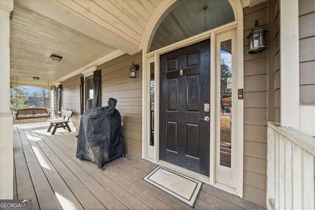 view of exterior entry with covered porch