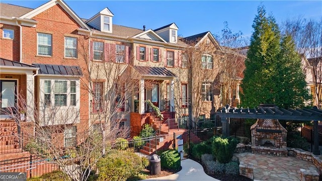 view of property featuring a patio area and a fireplace