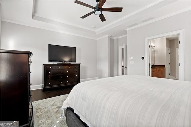 bedroom featuring ensuite bath, a raised ceiling, ceiling fan, crown molding, and dark hardwood / wood-style floors