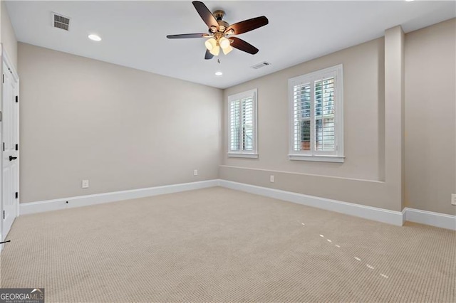 carpeted spare room featuring ceiling fan