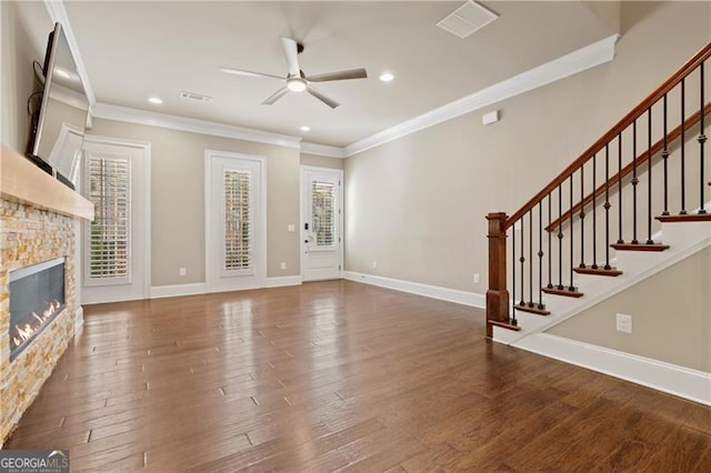 unfurnished living room featuring a fireplace, dark hardwood / wood-style flooring, ceiling fan, and crown molding