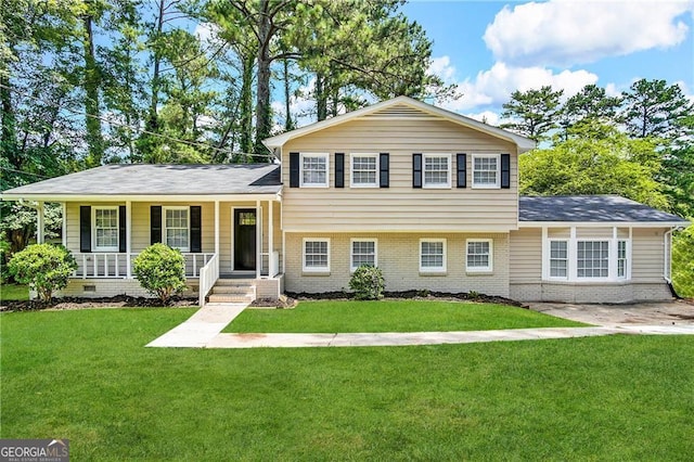 split level home with a front yard and a porch