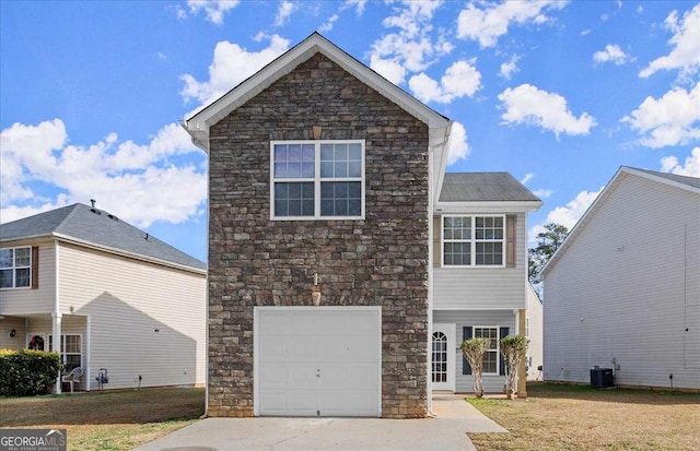 front of property with a front lawn, cooling unit, and a garage