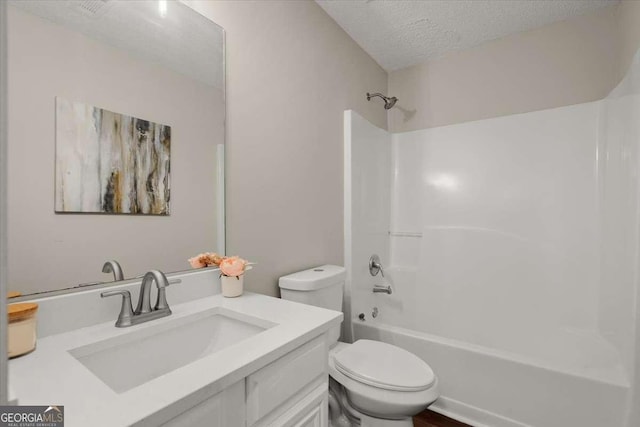 full bathroom with vanity, shower / bath combination, a textured ceiling, and toilet