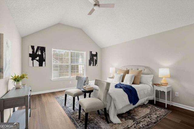 bedroom with vaulted ceiling, ceiling fan, dark hardwood / wood-style floors, and a textured ceiling