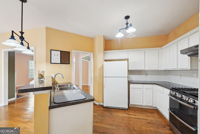 kitchen with range with two ovens, freestanding refrigerator, white cabinetry, and a sink