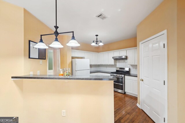 kitchen with hanging light fixtures, freestanding refrigerator, white cabinetry, double oven range, and a peninsula