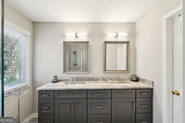 bathroom with a sink and double vanity