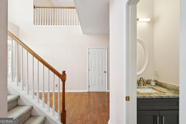 stairway with baseboards and wood finished floors