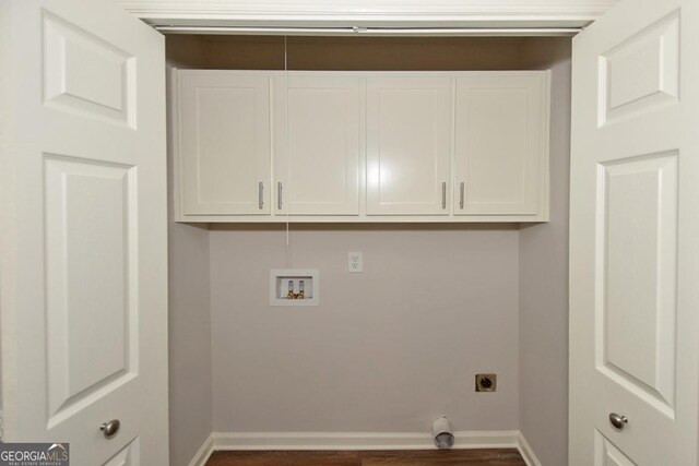 laundry room with electric dryer hookup, cabinets, dark wood-type flooring, and hookup for a washing machine