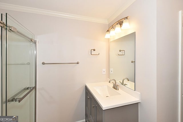 bathroom featuring vanity, a shower with shower door, and ornamental molding