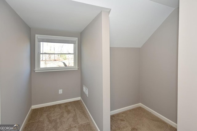 bonus room featuring light colored carpet and vaulted ceiling