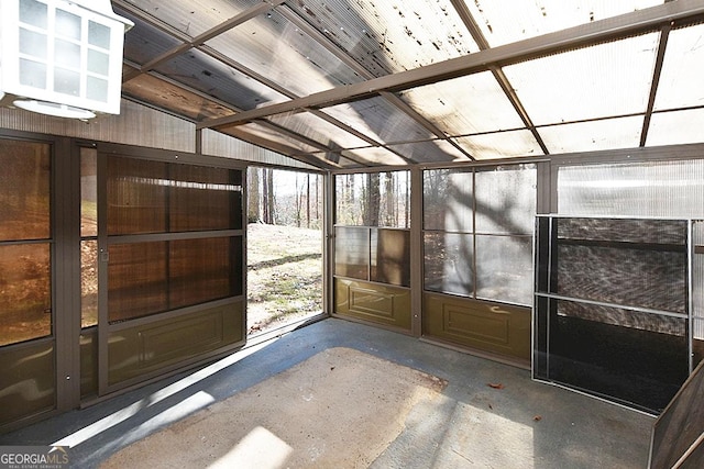 unfurnished sunroom with vaulted ceiling