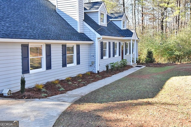 view of side of home featuring a lawn