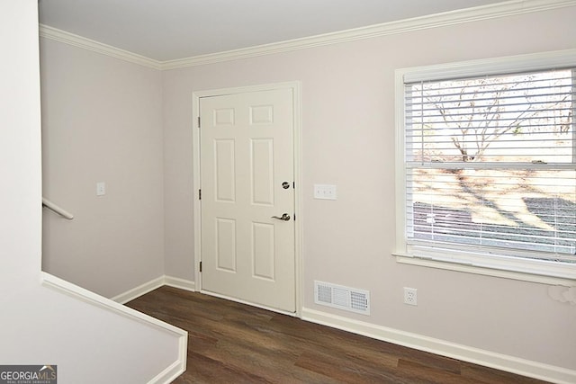 entrance foyer with dark wood-type flooring and ornamental molding