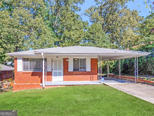 view of front of home with a front yard, a carport, and covered porch