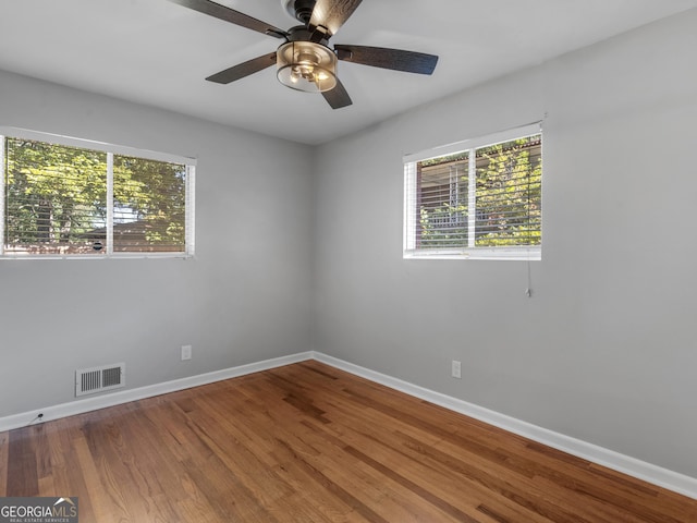 spare room with ceiling fan and wood-type flooring