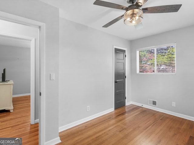 unfurnished bedroom with light wood-type flooring and ceiling fan