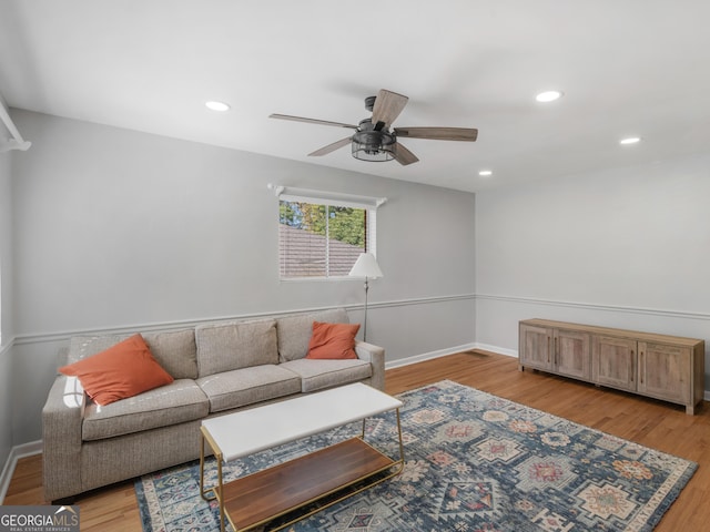 living room featuring ceiling fan and light wood-type flooring