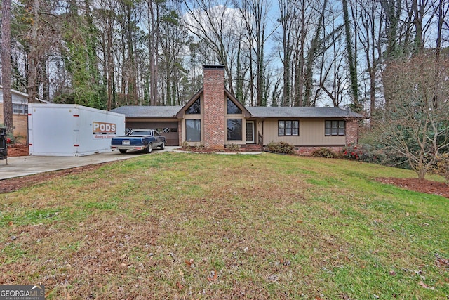 view of front facade with a garage and a front lawn