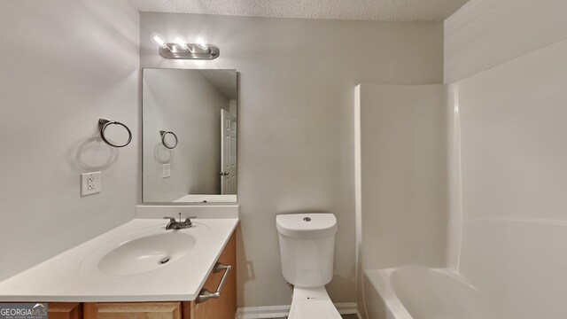 full bathroom featuring vanity, tub / shower combination, a textured ceiling, and toilet