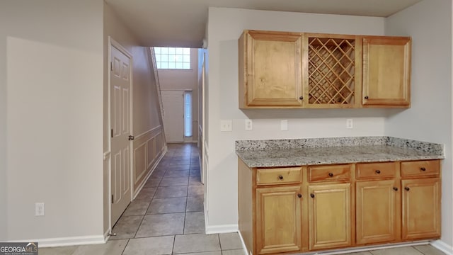 kitchen featuring light stone counters and light tile patterned flooring