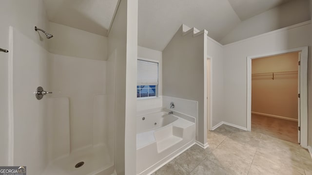 bathroom featuring tile patterned floors, lofted ceiling, and shower with separate bathtub