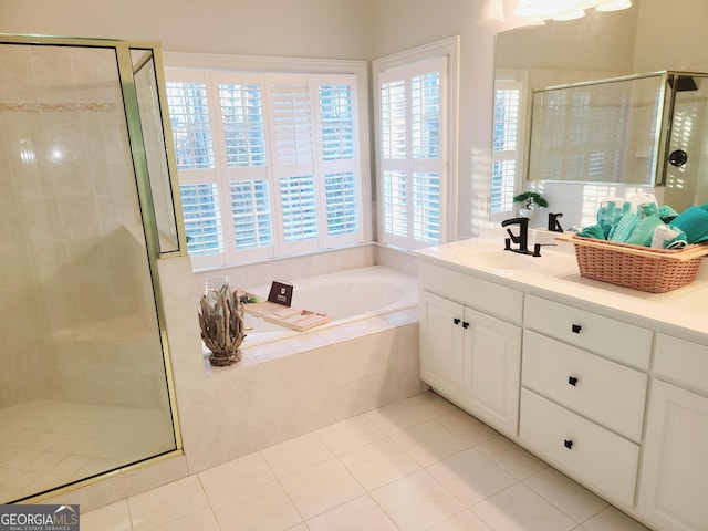 bathroom with tile patterned flooring and shower with separate bathtub