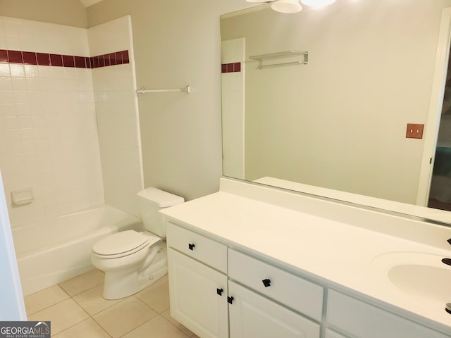 full bathroom featuring tile patterned flooring, vanity, tiled shower / bath combo, and toilet