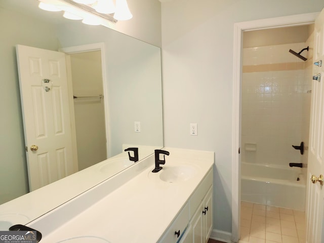 bathroom featuring tile patterned floors, vanity, and tiled shower / bath