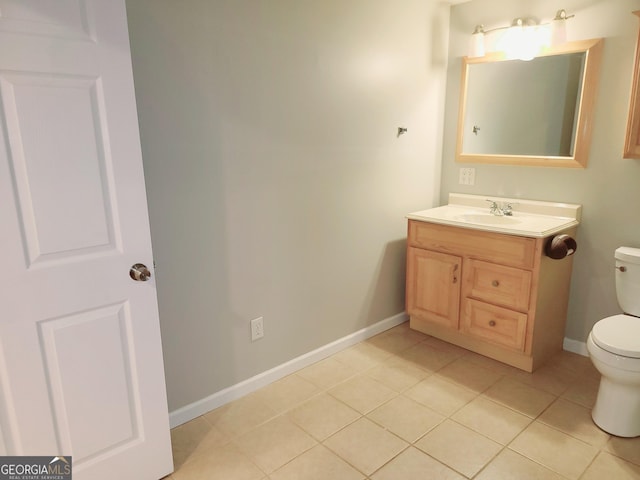 bathroom featuring tile patterned flooring, vanity, and toilet