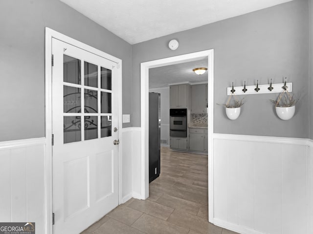 entryway with a textured ceiling