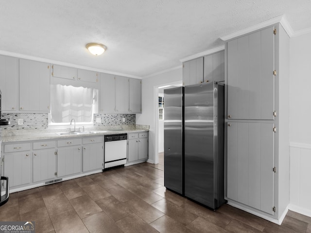 kitchen with sink, stainless steel fridge, dishwasher, and crown molding