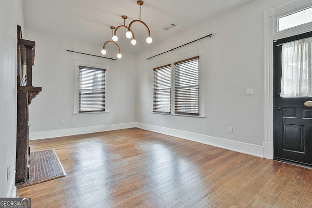 entrance foyer featuring hardwood / wood-style flooring and an inviting chandelier