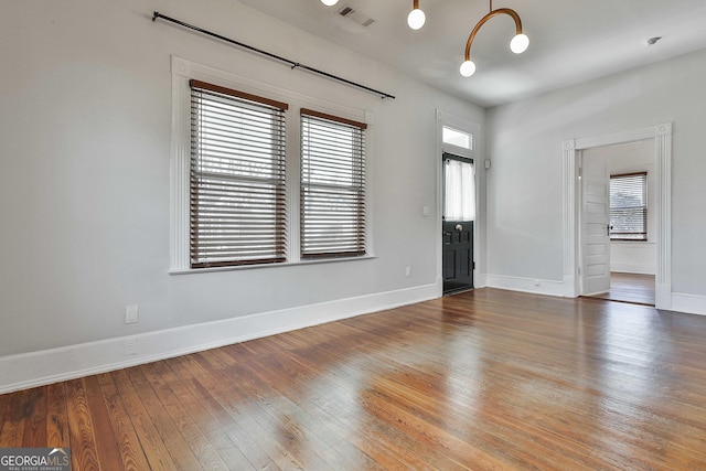 unfurnished room with wood-type flooring