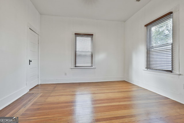 unfurnished room featuring light hardwood / wood-style flooring and a healthy amount of sunlight