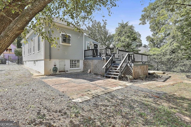 back of house featuring a patio area and a wooden deck