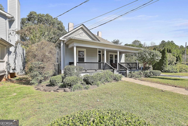 bungalow-style house featuring a porch and a front lawn