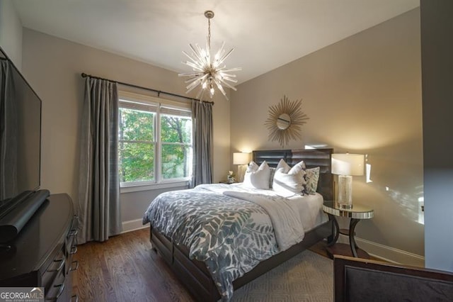 bedroom with lofted ceiling, dark hardwood / wood-style floors, and a chandelier