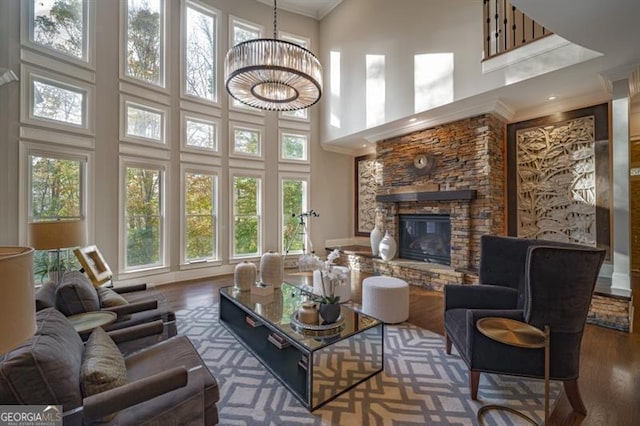 living room with an inviting chandelier, a towering ceiling, and dark hardwood / wood-style flooring