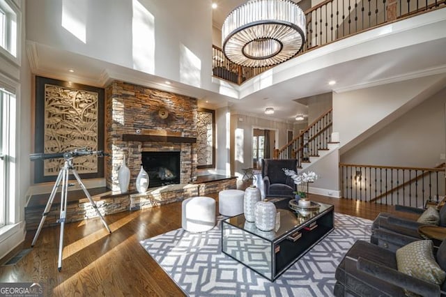 living room with hardwood / wood-style floors, plenty of natural light, and a high ceiling