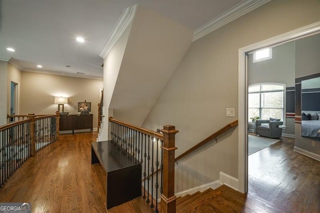 staircase with hardwood / wood-style floors and crown molding