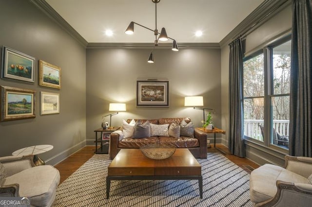 living area with ornamental molding and dark hardwood / wood-style floors