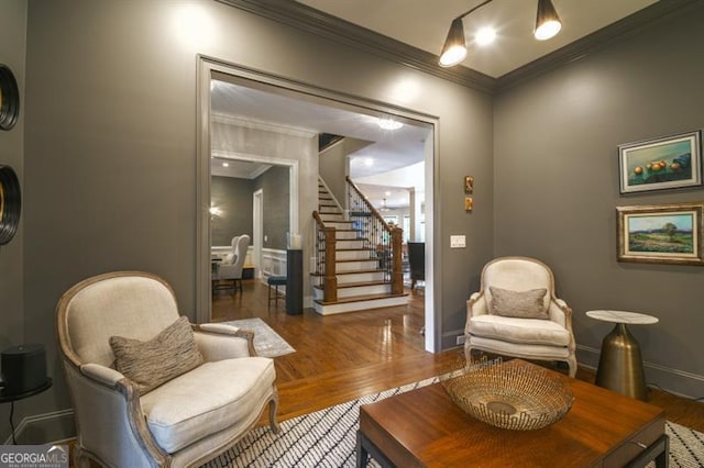 living area featuring crown molding and dark wood-type flooring