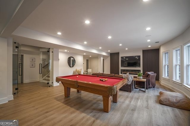 game room with pool table and light hardwood / wood-style floors