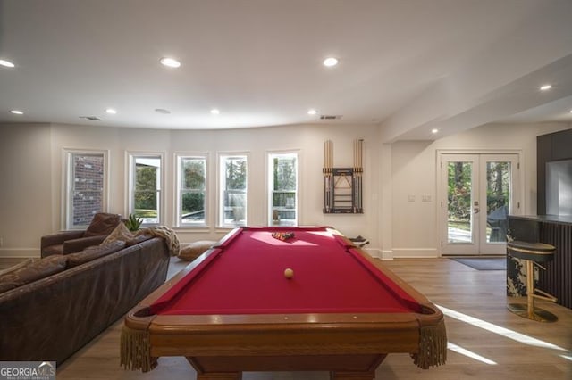 recreation room with french doors, billiards, hardwood / wood-style floors, and a wealth of natural light