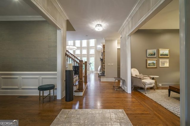 foyer entrance featuring dark wood-type flooring and ornamental molding